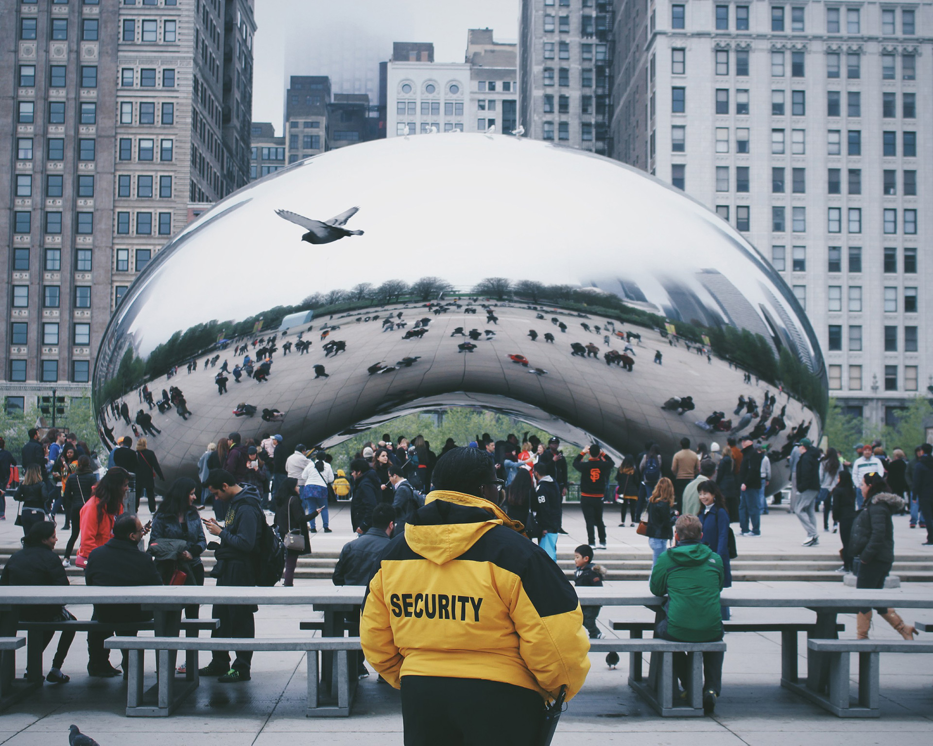 view of the cloud gate with a security guard standing in front