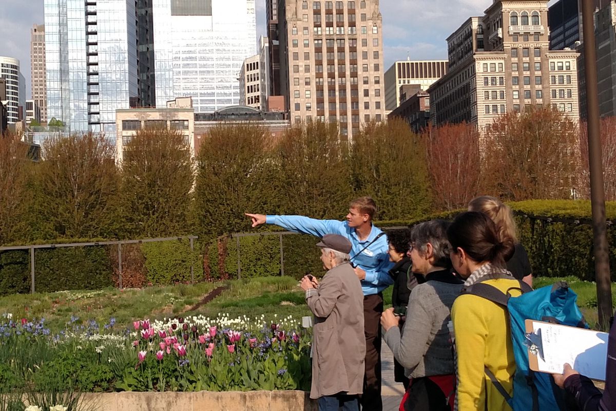 a man guiding guests and pointing to a point of interest