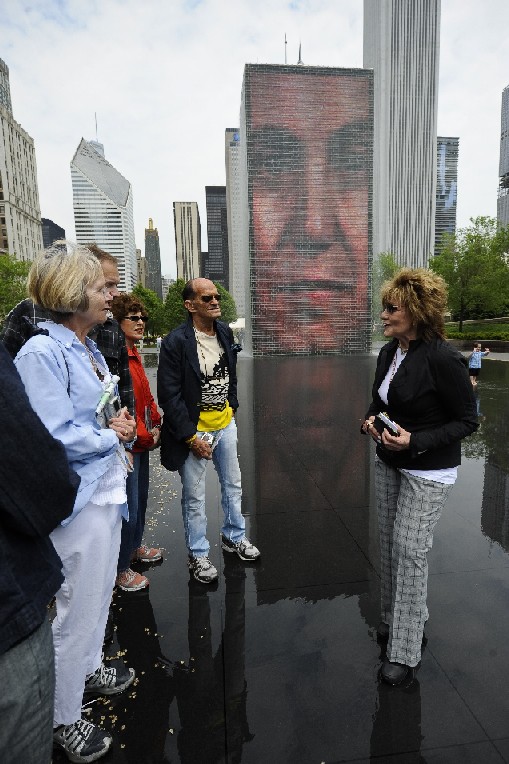 a guide showing tourists the crown plaza